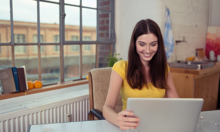 Smiling woman using a laptop computer
