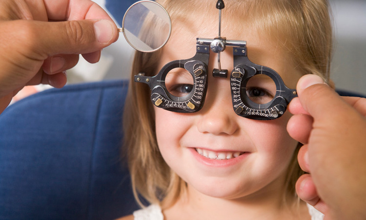 Child smiling while getting an eye exam