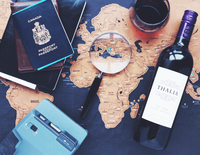 Symbolic travel-themed items sitting on top of a map