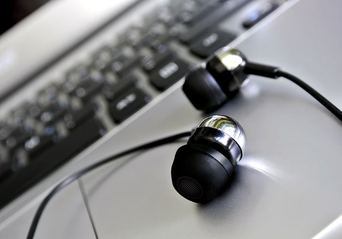 Headphones resting on laptop computer