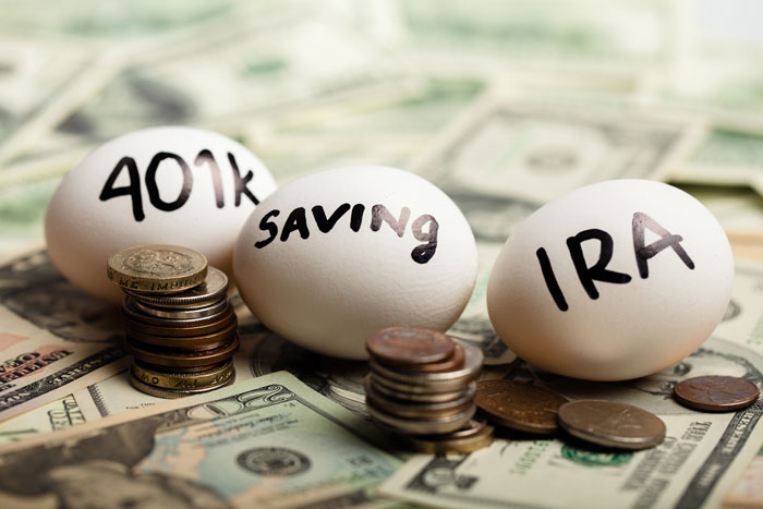 Three eggs with "401k" "saving" and "IRA" written on them