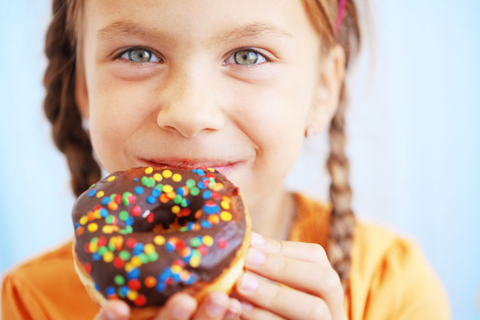 Young girl holding a donut