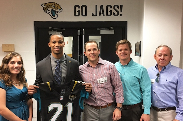 Member Benefits executives with a Jacksonville Jaguars player
