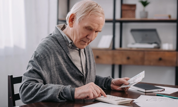 Elderly man doing paperwork