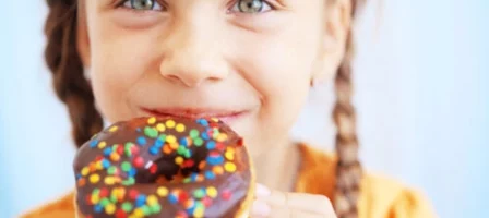 Young Girl Holding A Donut