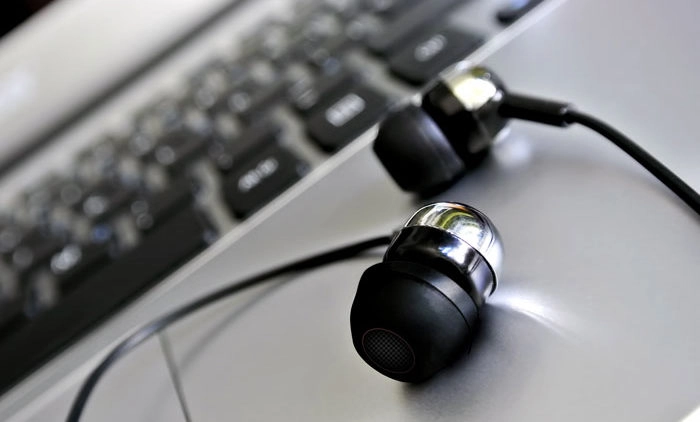 Headphones resting on laptop computer