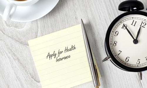 "Apply For Health Insurance" Written On A Notepad