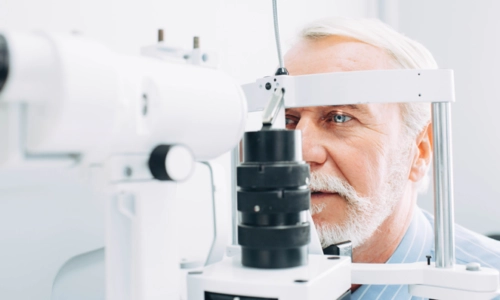 Elderly Man Getting Eye Exam For Cataracts