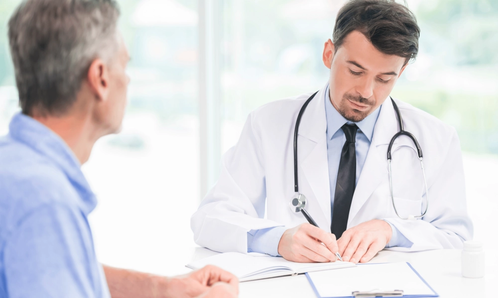 Doctor writing information with patient