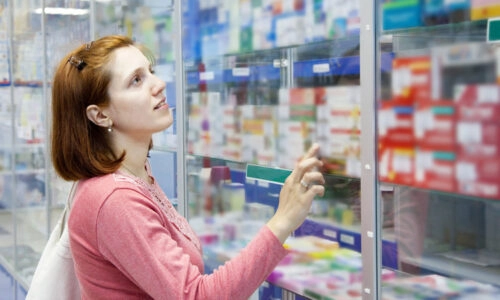 Woman Browsing Products At Pharmacy